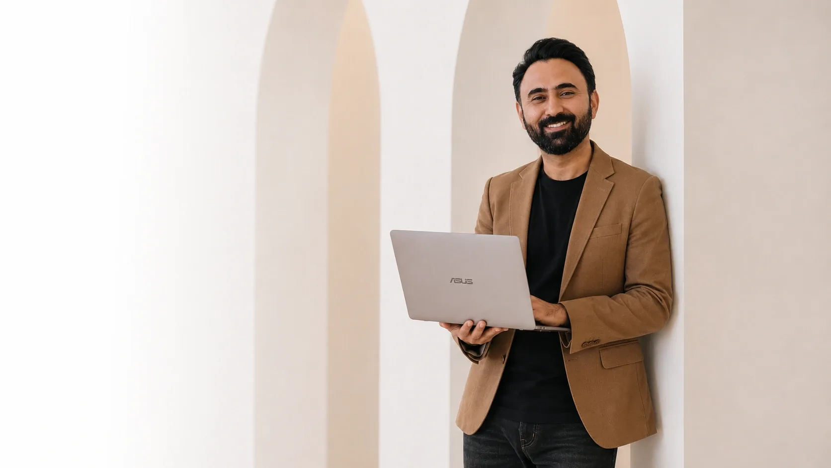 Amar Goraya, website designer in Timaru, holding a laptop